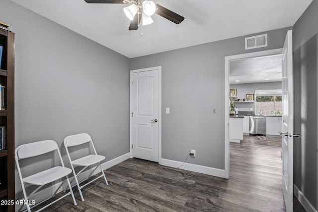 4502 W Continental Dr, Glendale, AZ 85308 - sitting room featuring ceiling fan, dark wood finished floors, and baseboards