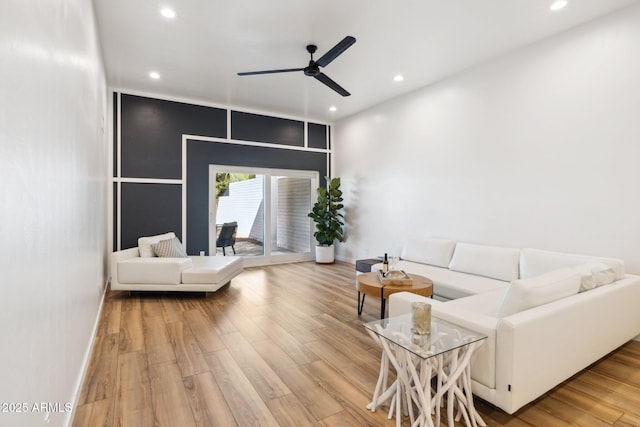 living room featuring baseboards, ceiling fan, recessed lighting, and wood finished floors