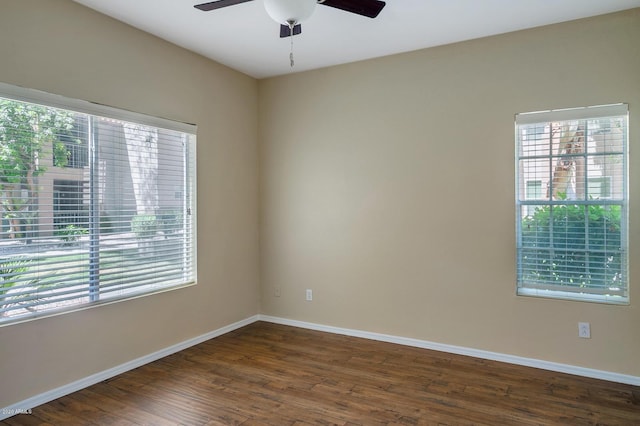 unfurnished room with ceiling fan and dark wood-type flooring