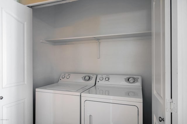 clothes washing area with washer and clothes dryer