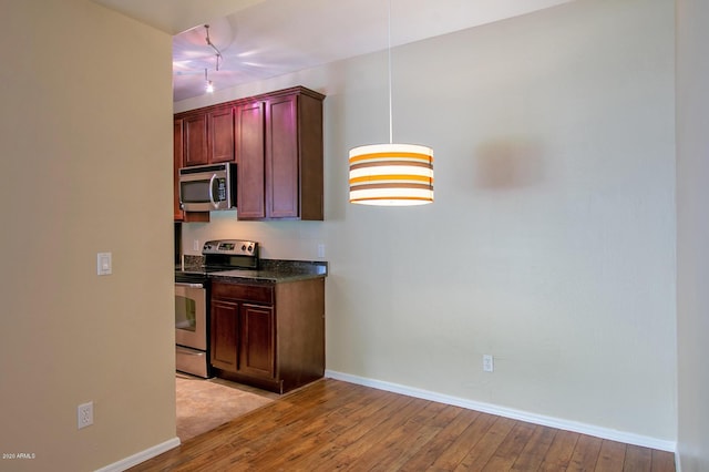 kitchen featuring appliances with stainless steel finishes and light hardwood / wood-style floors