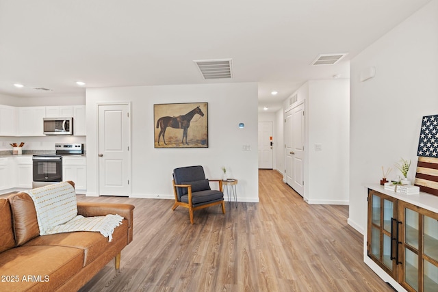 living room with light hardwood / wood-style floors