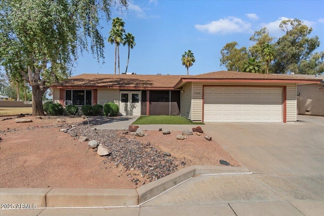 ranch-style house featuring a garage and concrete driveway