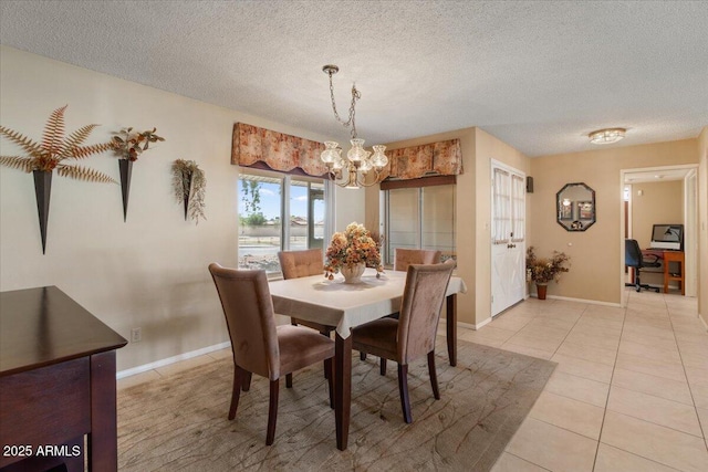 dining space featuring light tile patterned floors, baseboards, a chandelier, and a textured ceiling