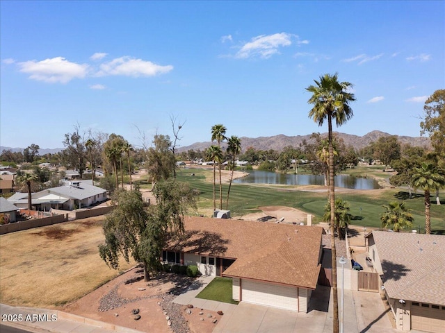drone / aerial view with golf course view and a water and mountain view