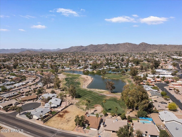birds eye view of property featuring a water and mountain view and a residential view