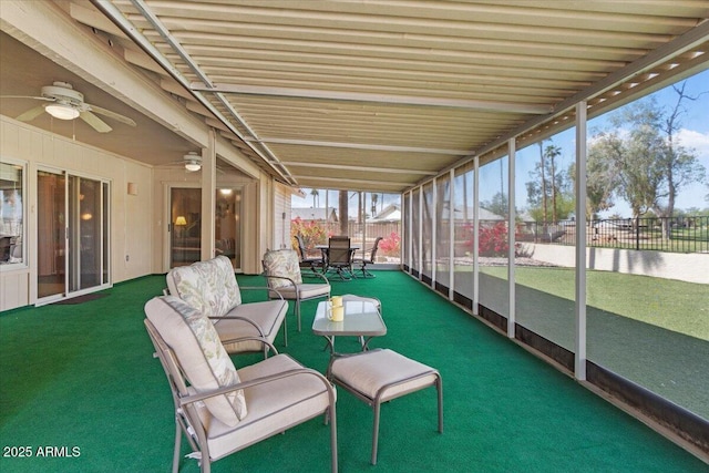 unfurnished sunroom featuring a ceiling fan