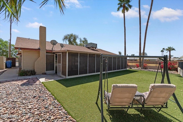view of yard with a fenced backyard and a sunroom