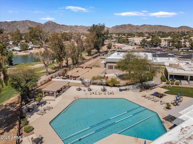 pool with fence, a patio area, and a mountain view