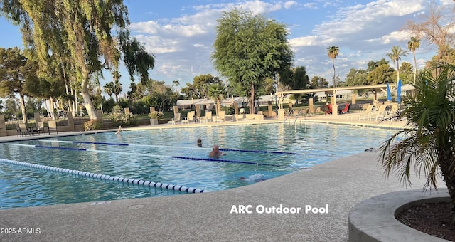 community pool featuring a patio area and fence