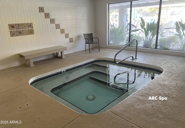view of pool with an indoor hot tub