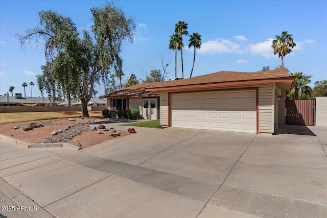 single story home featuring a garage, fence, driveway, and a gate