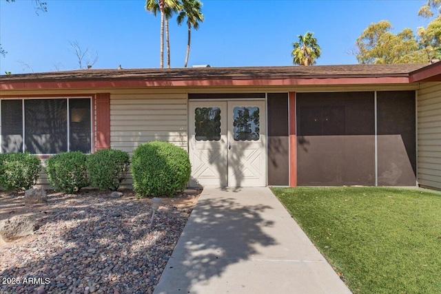 property entrance with a yard