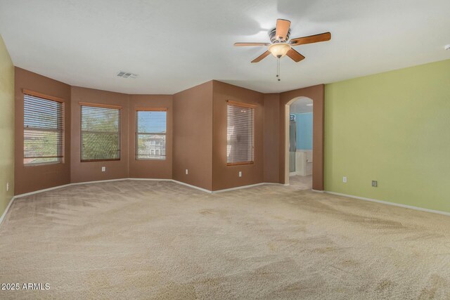 16527 N 71st Dr, Peoria, AZ 85382 - spare room with arched walkways, ceiling fan, carpet floors, and visible vents
