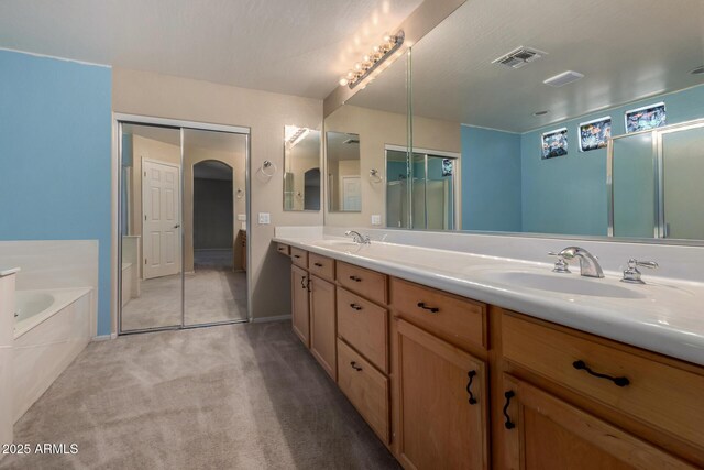 16527 N 71st Dr, Peoria, AZ 85382 - full bath with double vanity, visible vents, a sink, and a garden tub