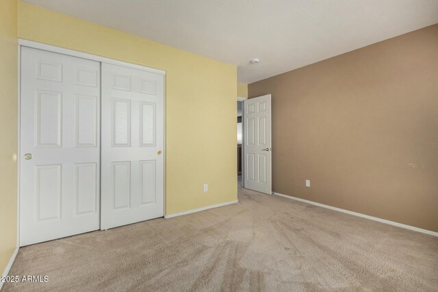 16527 N 71st Dr, Peoria, AZ 85382 - unfurnished bedroom with a closet, baseboards, and carpet flooring