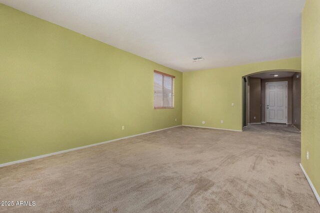16527 N 71st Dr, Peoria, AZ 85382 - carpeted spare room with visible vents, arched walkways, and baseboards