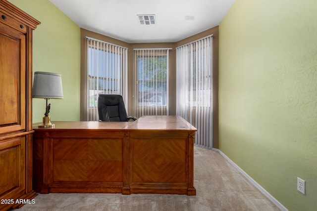 office space with baseboards, light colored carpet, and visible vents