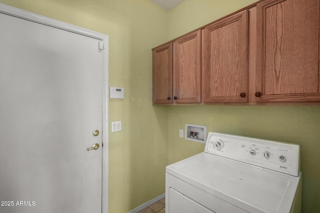 clothes washing area featuring cabinet space, baseboards, and washer / dryer