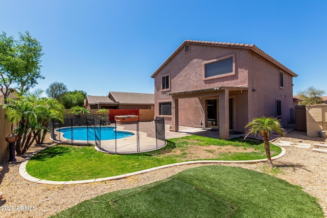 back of property with a yard, a patio, a fenced backyard, and stucco siding