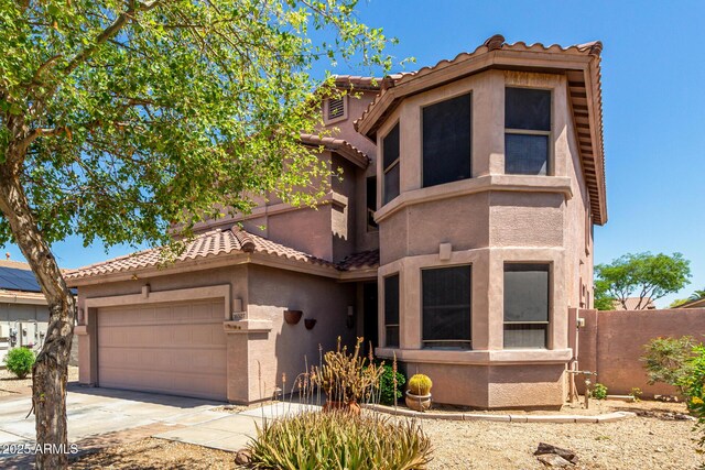 16527 N 71st Dr, Peoria, AZ 85382 - view of front of home featuring fence, an attached garage, stucco siding, a tiled roof, and driveway