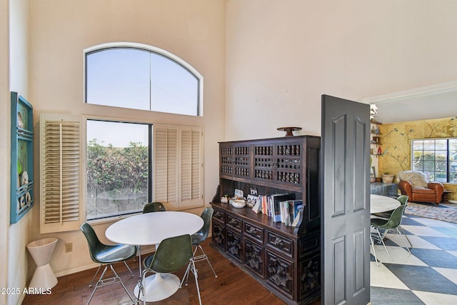 dining space featuring a towering ceiling