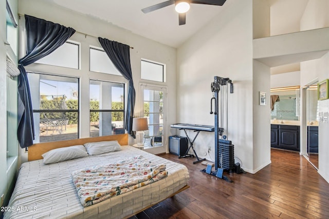 bedroom with dark wood-style floors, connected bathroom, a high ceiling, and ceiling fan