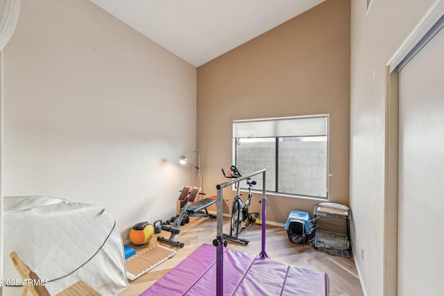 workout room with baseboards and wood finished floors