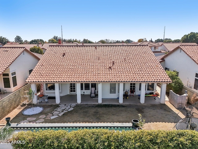 back of house with a patio