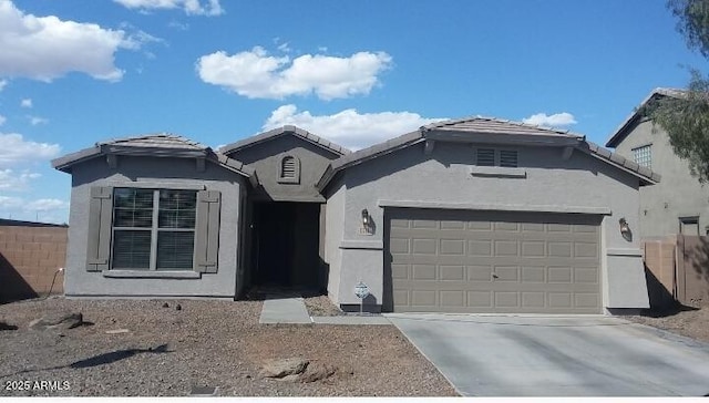 single story home with stucco siding, a tiled roof, concrete driveway, and a garage