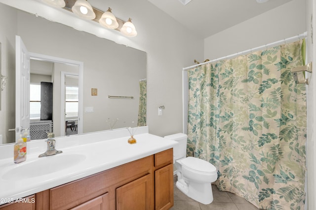 bathroom with a shower with curtain, vanity, toilet, and tile patterned floors