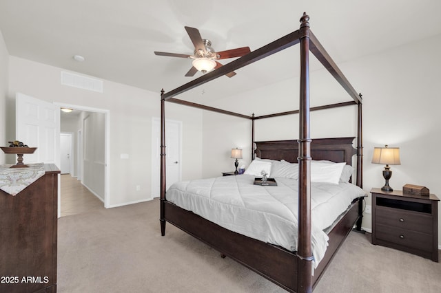 bedroom with a ceiling fan, visible vents, and light carpet