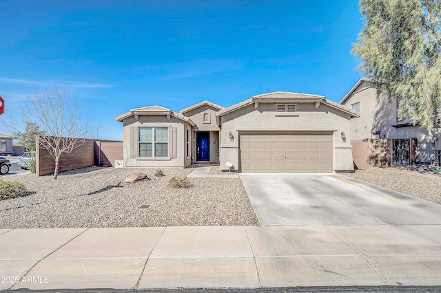 view of front of home with concrete driveway, fence, a garage, and stucco siding