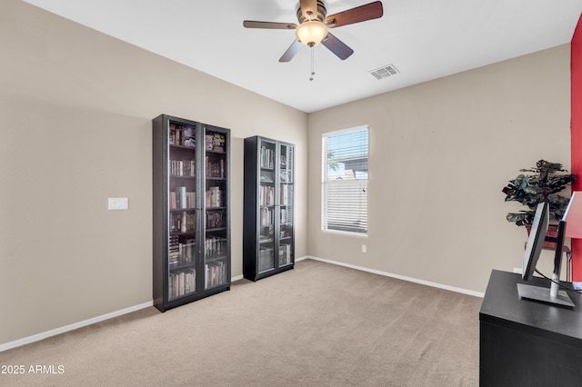 interior space with a ceiling fan, visible vents, and baseboards