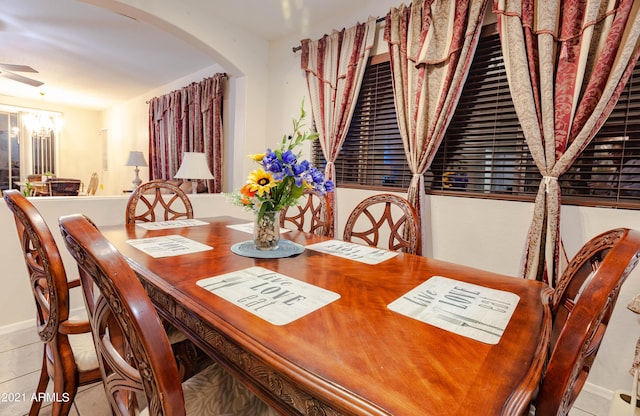 tiled dining area with an inviting chandelier