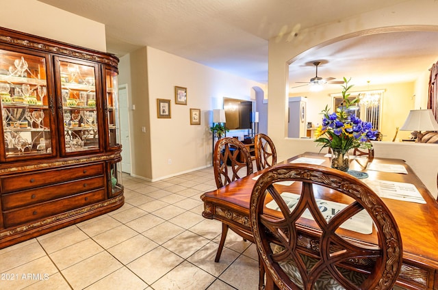 tiled dining area with ceiling fan