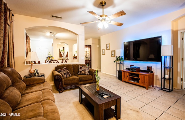 living room featuring ceiling fan and light tile patterned flooring