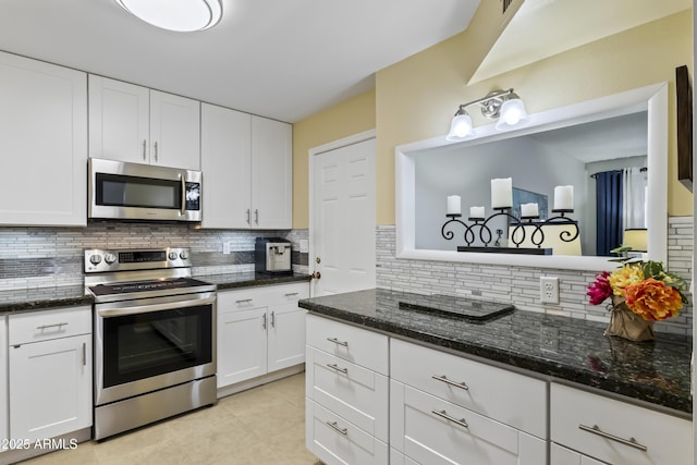 6263 E Duncan St, Mesa, AZ 85205 - kitchen with stainless steel appliances, tasteful backsplash, white cabinets, and light tile patterned floors