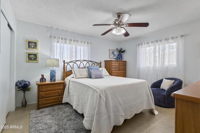 6263 E Duncan St, Mesa, AZ 85205 - bedroom featuring light tile patterned floors, a closet, ceiling fan, and a textured ceiling