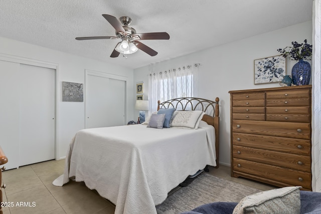 6263 E Duncan St, Mesa, AZ 85205 - bedroom featuring multiple closets, light tile patterned flooring, and a ceiling fan