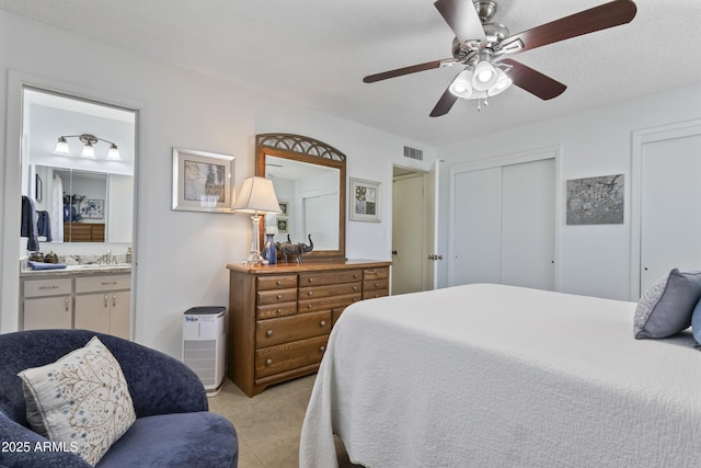6263 E Duncan St, Mesa, AZ 85205 - bedroom with connected bathroom, a ceiling fan, light tile patterned flooring, and two closets