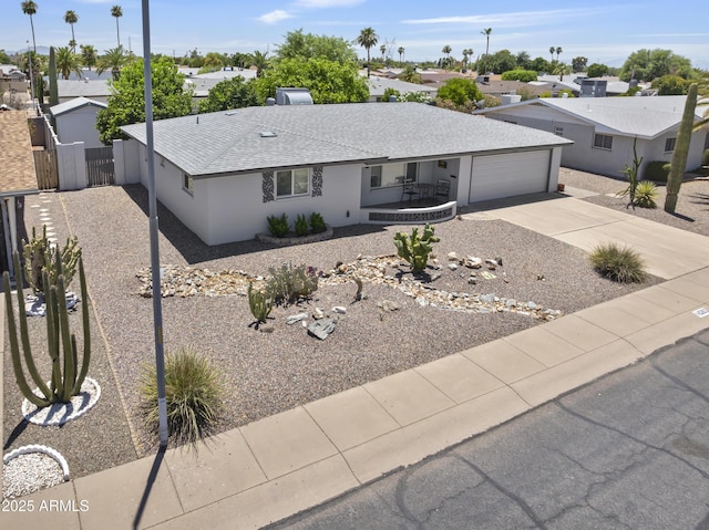 6263 E Duncan St, Mesa, AZ 85205 - single story home featuring concrete driveway, an attached garage, a residential view, a gate, and covered porch