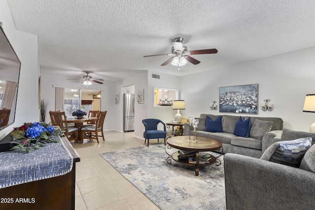 6263 E Duncan St, Mesa, AZ 85205 - living area with ceiling fan, light tile patterned floors, and a textured ceiling