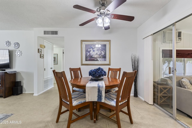 6263 E Duncan St, Mesa, AZ 85205 - dining space with a ceiling fan, a textured ceiling, a wall mounted AC, and light tile patterned flooring
