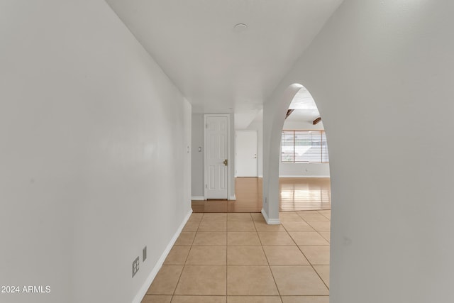 corridor featuring light tile patterned floors