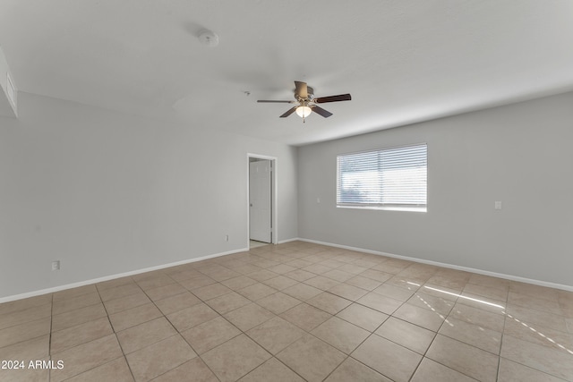 empty room with baseboards and ceiling fan