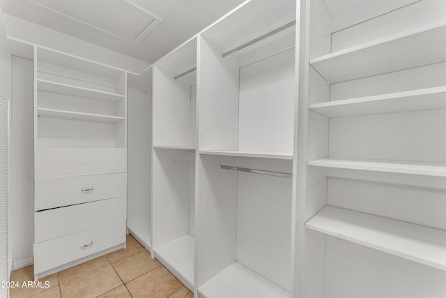 spacious closet with light tile patterned floors