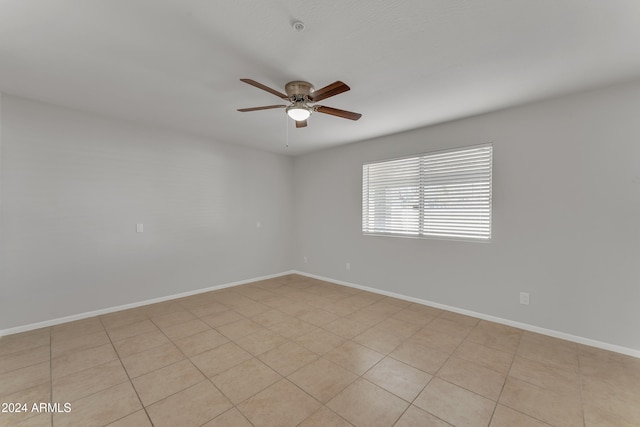 tiled empty room with ceiling fan