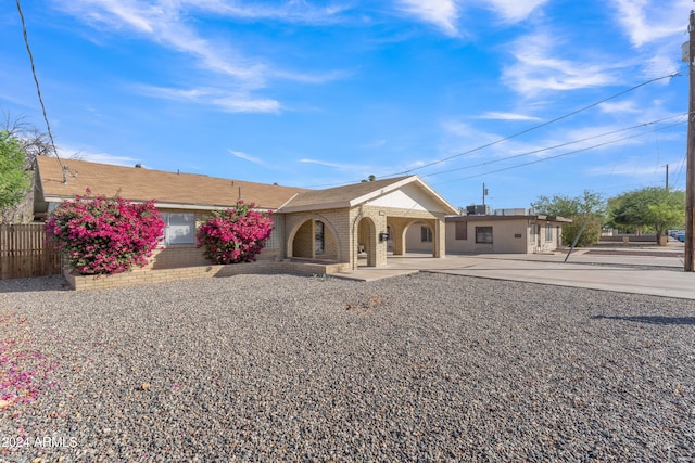 single story home featuring a patio area, brick siding, and fence