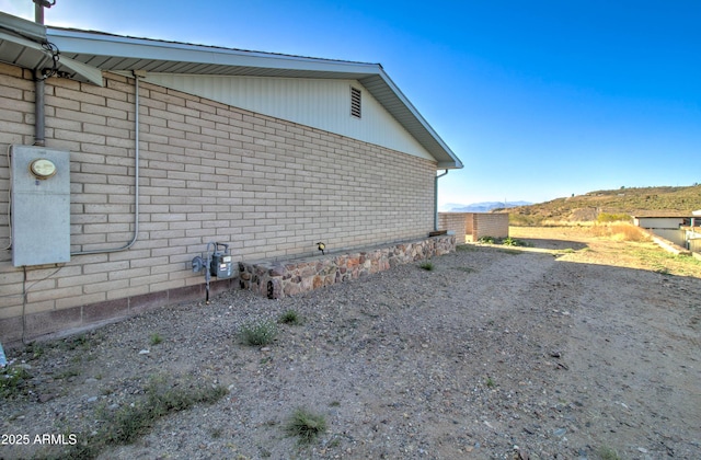 view of side of home with brick siding